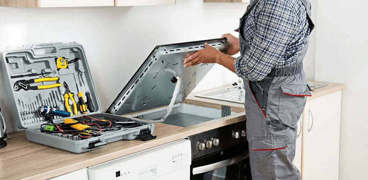 Handyman repairing a cooktop and checking wiring connections in Orlando, FL