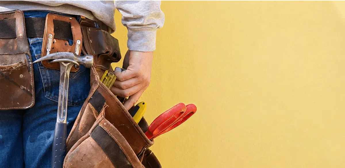 Handyman with tool belt ready for home repairs and maintenance in Orlando, FL