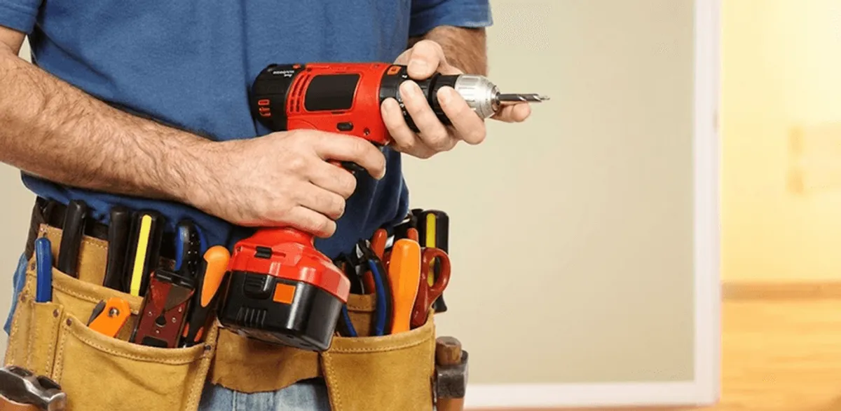 Handyman holding a power drill for home repairs and installations in Orlando, FL